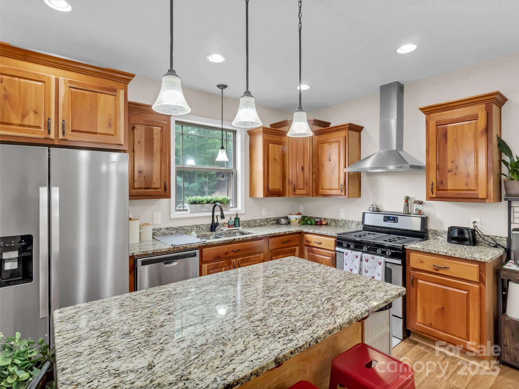 4823 Max Patch Road Clyde, NC 28721 - Photo 10 of 47 a kitchen with stainless steel appliances granite countertop a sink stove and refrigerator