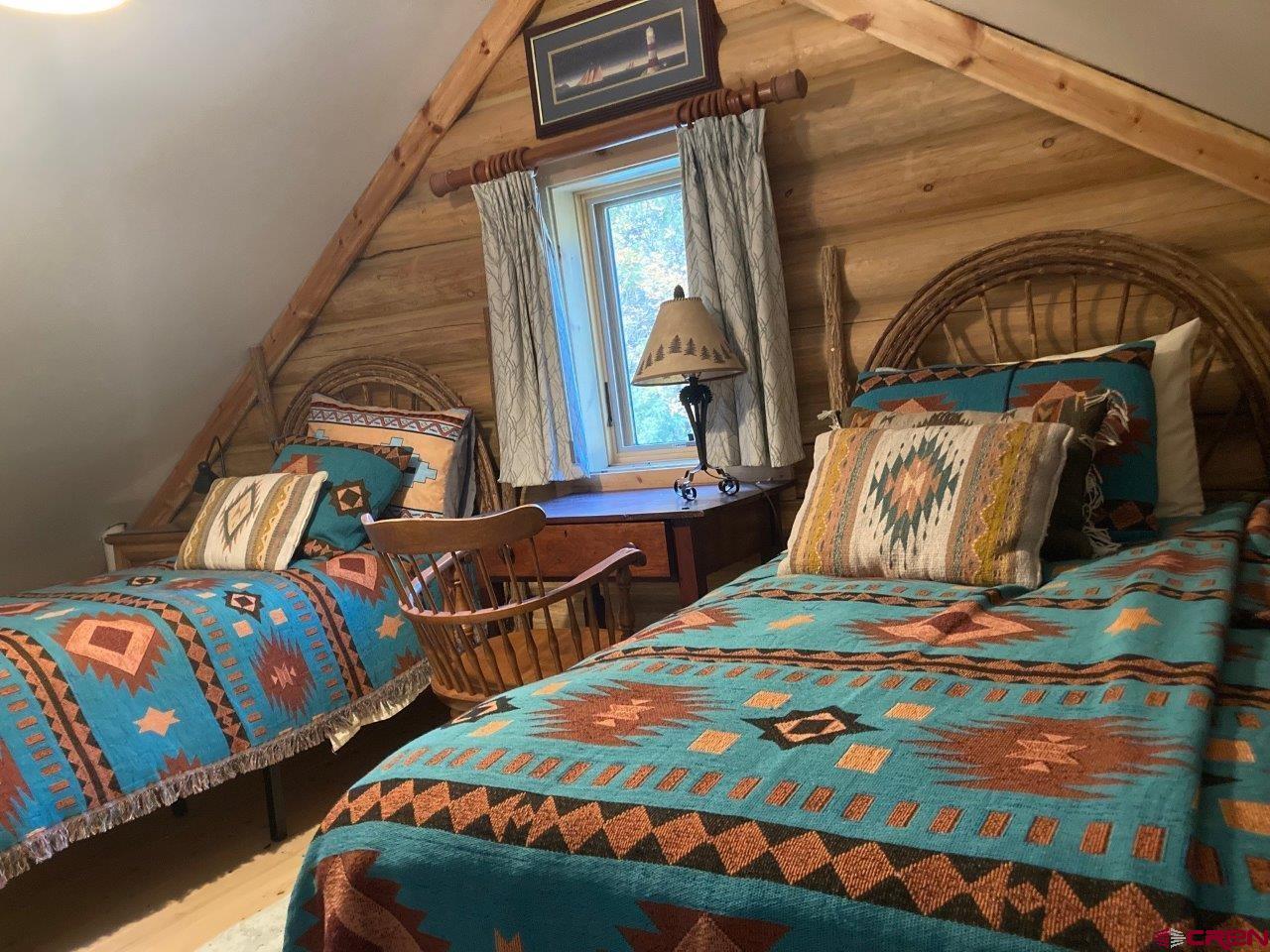 68 Sanborn Park Road Norwood, CO 81423 - Photo 21 of 33 a bedroom with two beds and a window