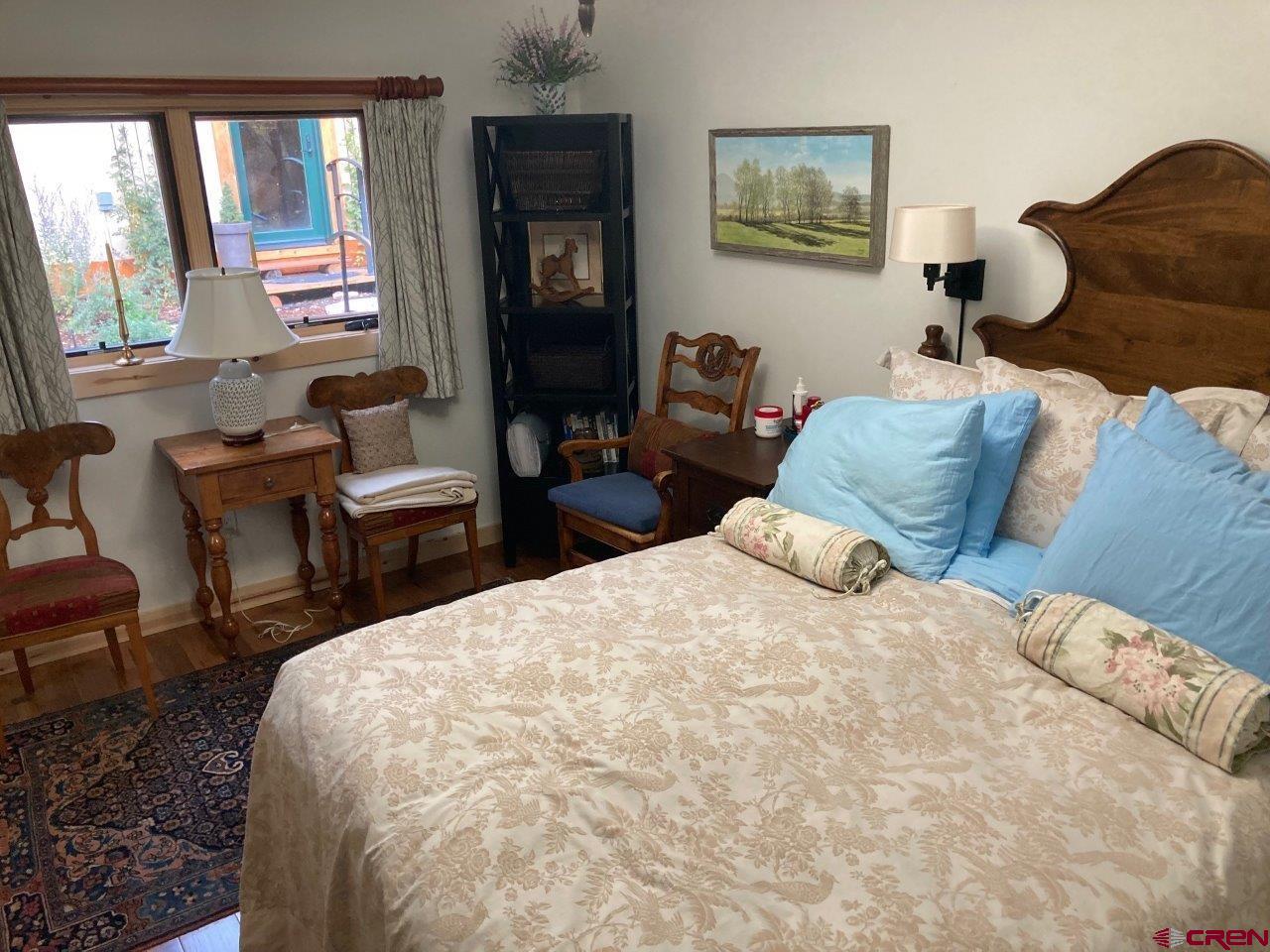 68 Sanborn Park Road Norwood, CO 81423 - Photo 23 of 33 a bedroom with a bed and wooden floor