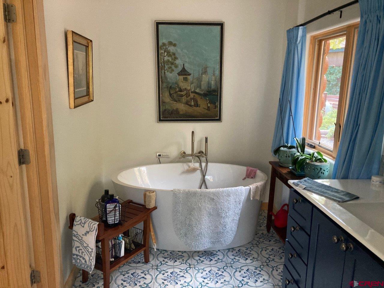 68 Sanborn Park Road Norwood, CO 81423 - Photo 26 of 33 a white bath tub sitting in a bathroom next to a window