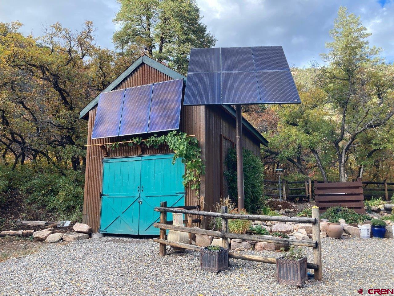68 Sanborn Park Road Norwood, CO 81423 - Photo 30 of 33 a backyard of a house with barbeque oven fire pit table and chairs