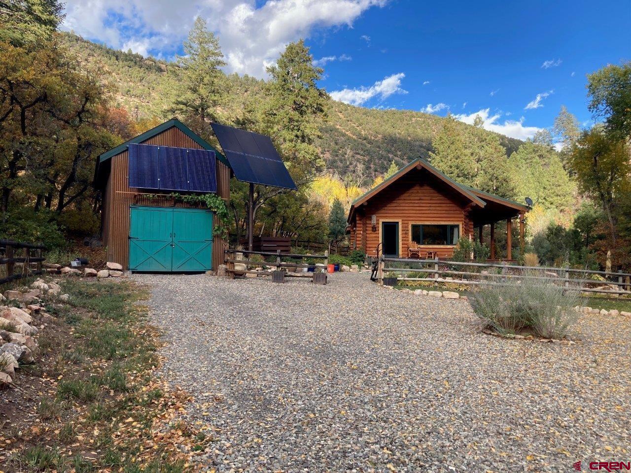 68 Sanborn Park Road Norwood, CO 81423 - Photo 6 of 33 a front view of a house with a yard and garage