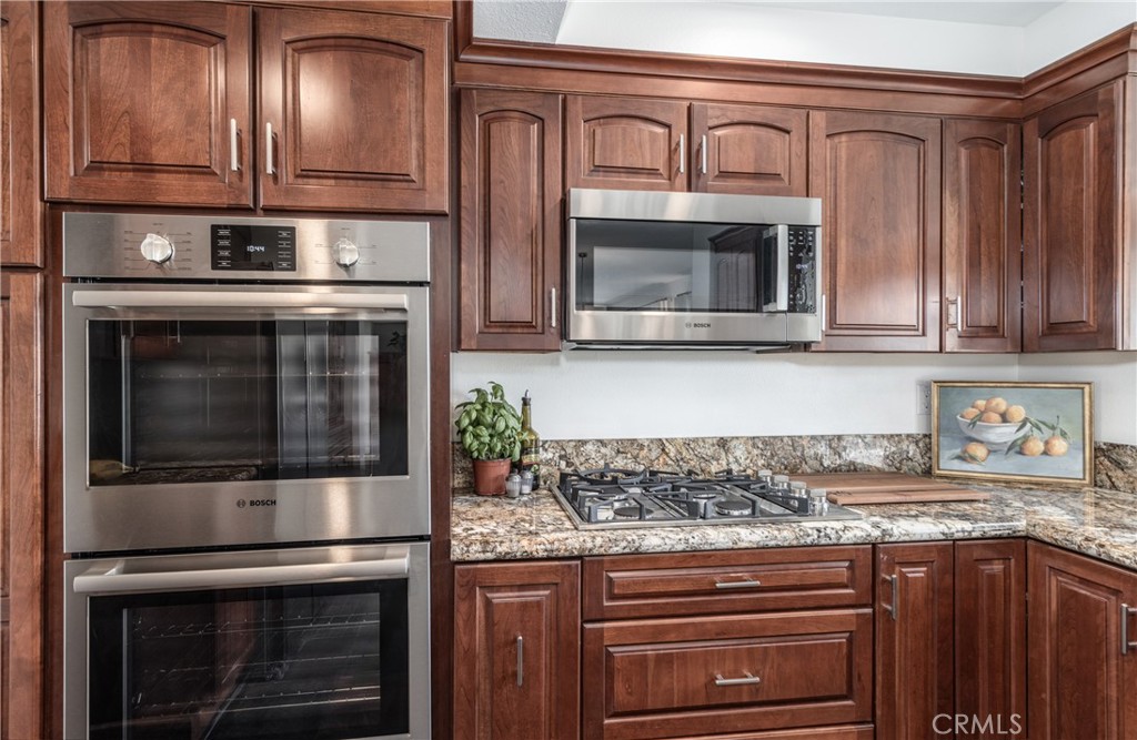 1951 Annapolis Circle Corona, CA 92881 - Photo 11 of 42 a kitchen with granite countertop stainless steel appliances and stove top oven
