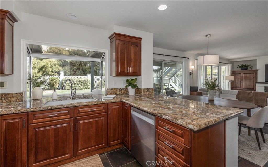 1951 Annapolis Circle Corona, CA 92881 - Photo 13 of 42 a kitchen with a sink a counter top space and living room