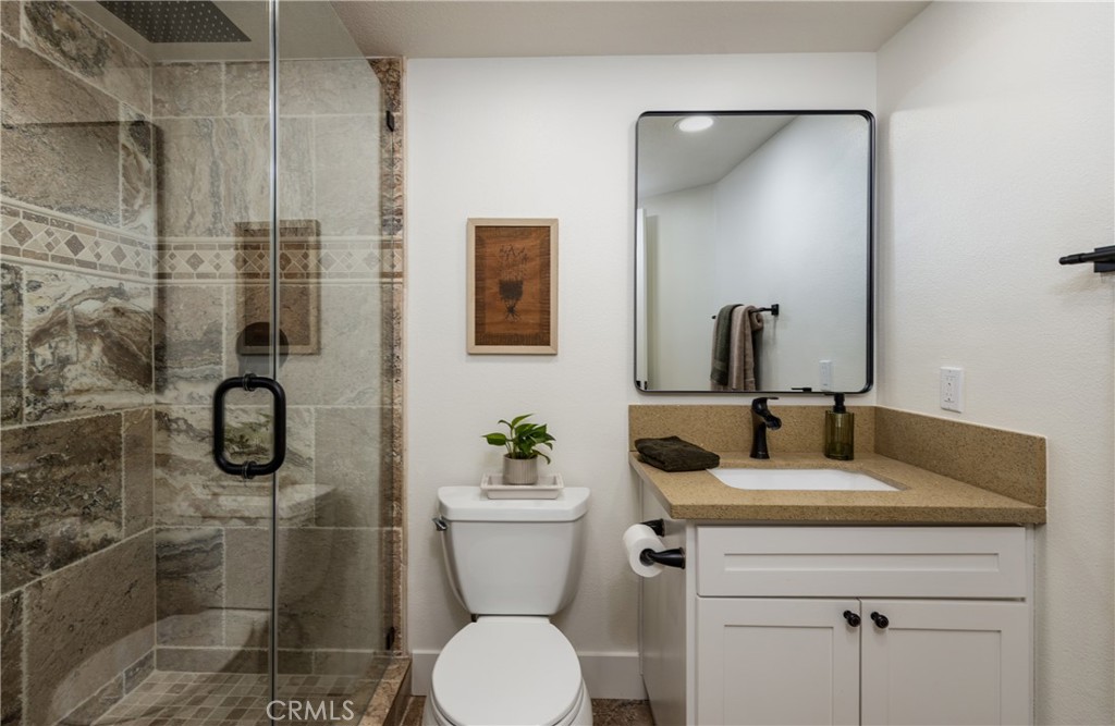 1951 Annapolis Circle Corona, CA 92881 - Photo 19 of 42 a bathroom with a granite countertop sink toilet and shower