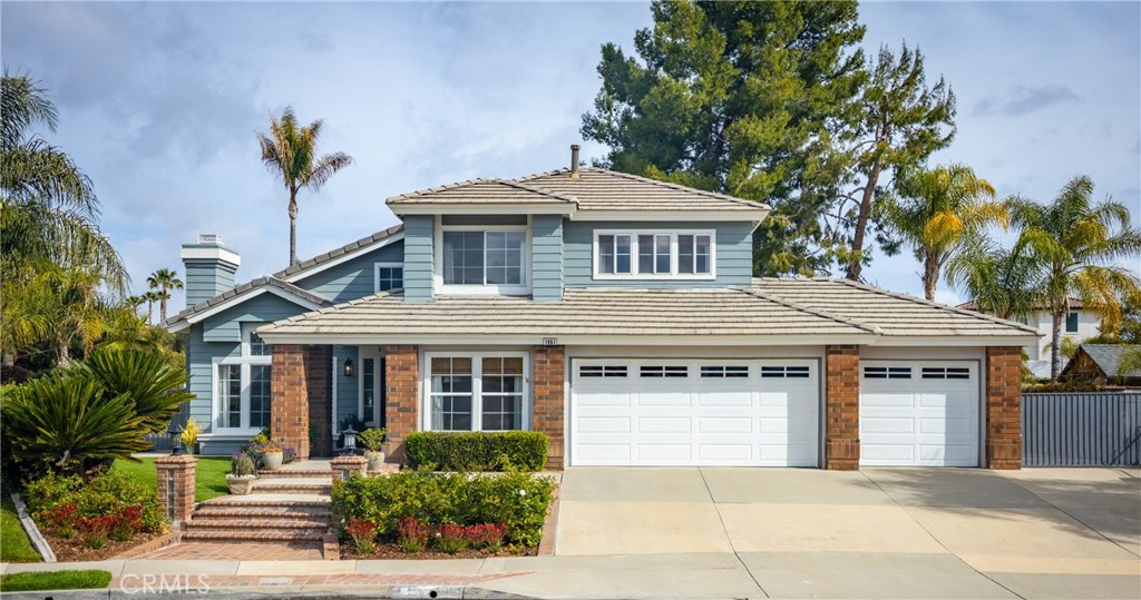 1951 Annapolis Circle Corona, CA 92881 - Photo 2 of 42 a front view of a house with a yard and garage