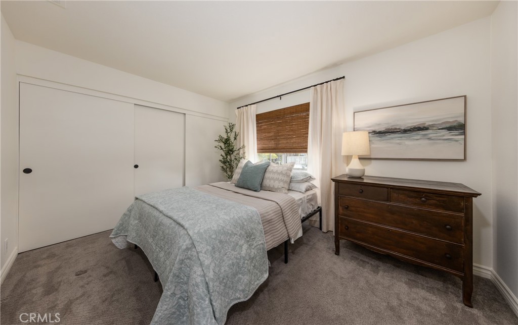 1951 Annapolis Circle Corona, CA 92881 - Photo 28 of 42 a spacious bedroom with a bed and a window