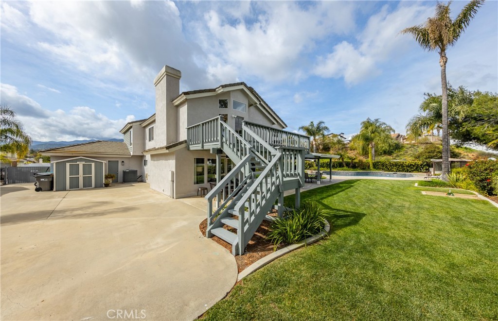 1951 Annapolis Circle Corona, CA 92881 - Photo 34 of 42 a view of a house with large trees and a yard