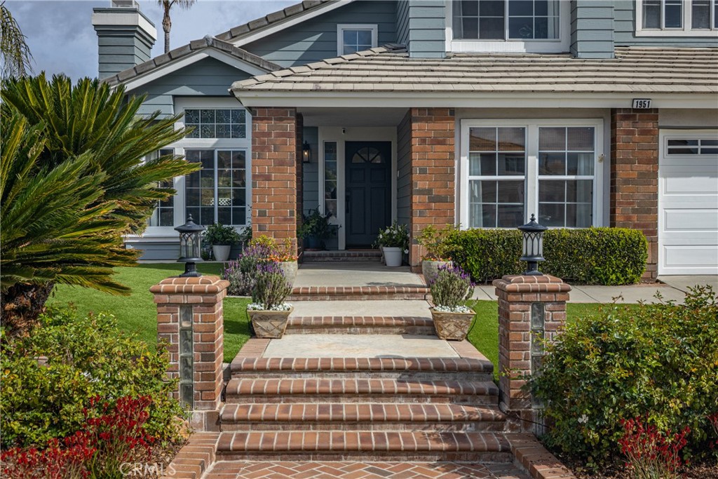 1951 Annapolis Circle Corona, CA 92881 - Photo 4 of 42 a front view of a house with a garden