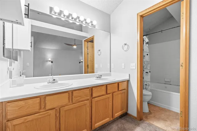 a bathroom with a double vanity sink and mirror with shower