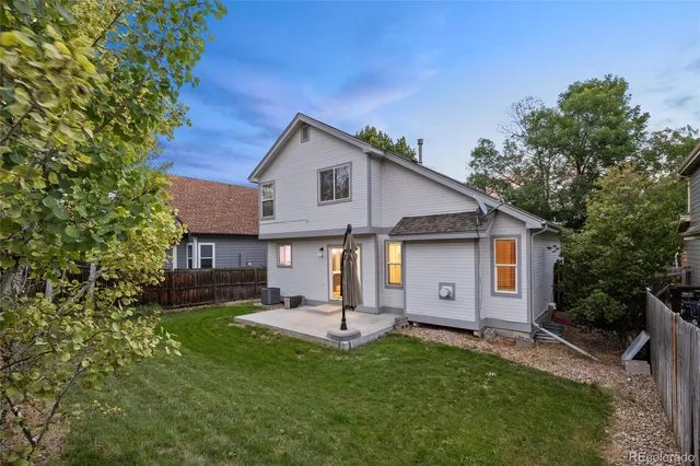a view of a house with a yard and sitting area