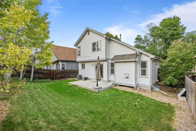 a view of a house with a yard and sitting area