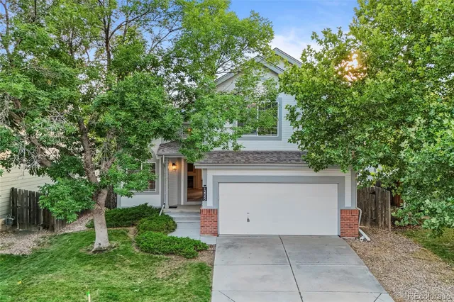 a view of a house with a tree