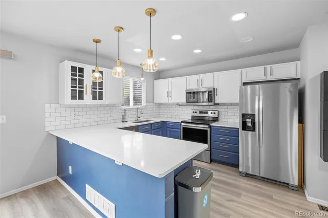 a kitchen with a refrigerator a sink and a oven