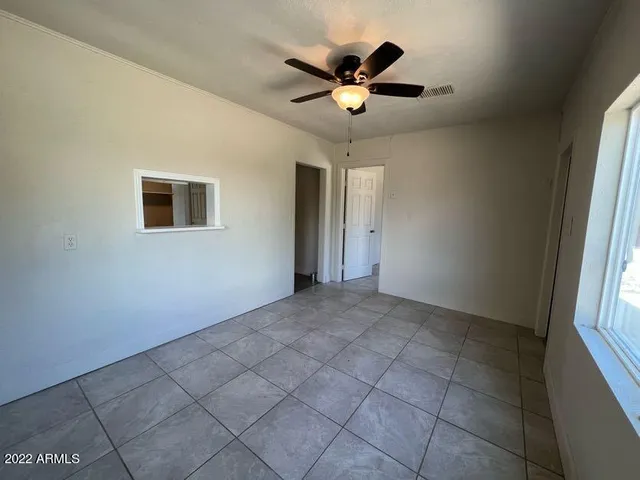 a view of a livingroom with a ceiling fan and window