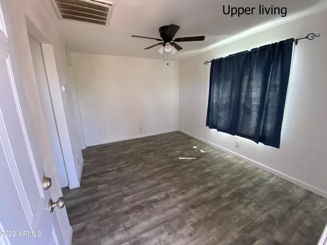 a kitchen with sink a refrigerator and wooden floor