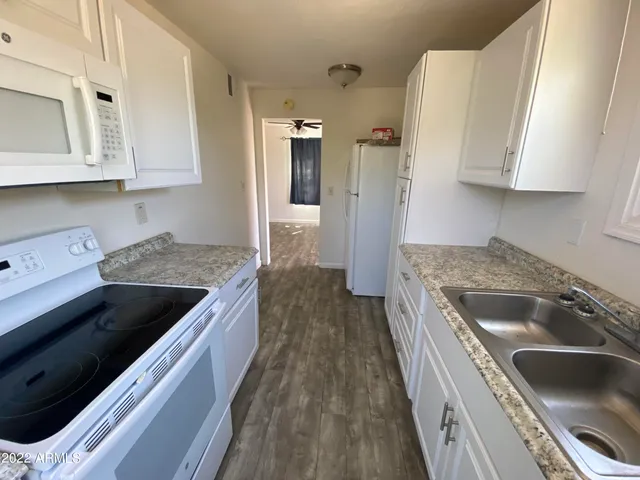 a bathroom with a sink toilet and mirror