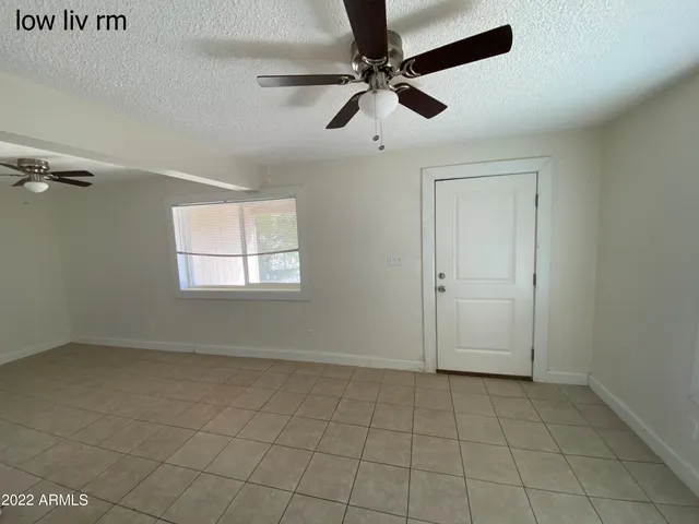 a view of a livingroom with a ceiling fan and window