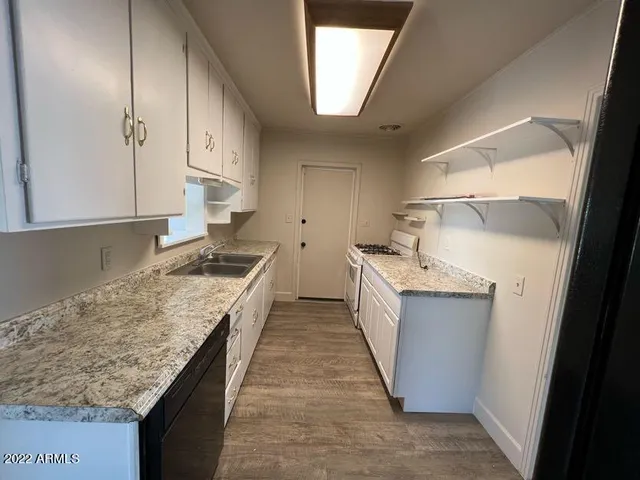 a kitchen with a sink stove and cabinets