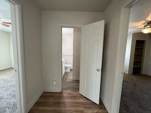 a view of a hallway with wooden floor