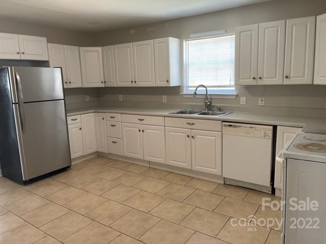178 Quail Ridge Lane Fort Mill, SC 29708 - Photo 4 of 25 a kitchen with a sink a refrigerator and cabinets
