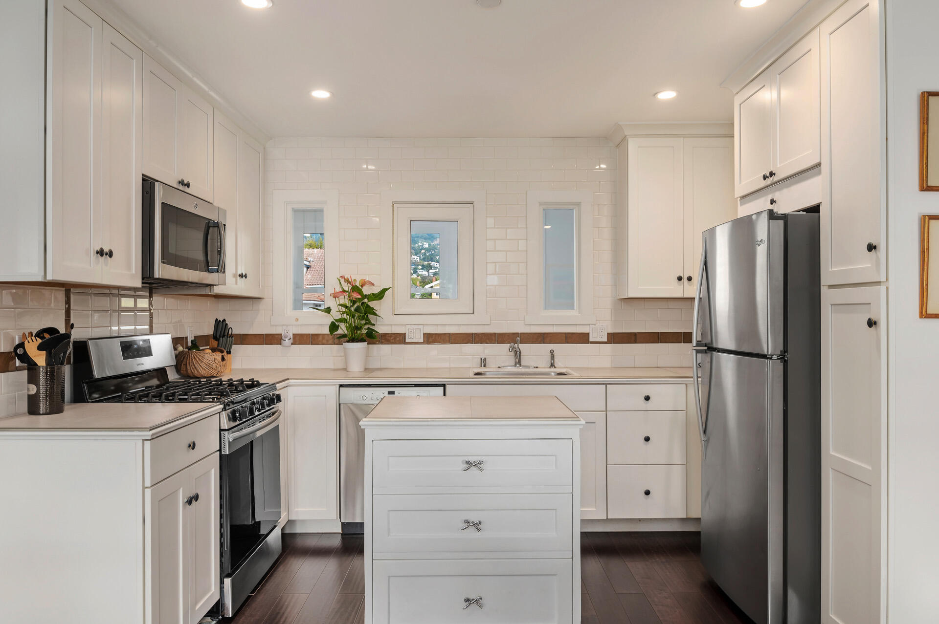 Undisclosed Address Santa Barbara, CA 93101 - Photo 11 of 27 a kitchen with white cabinets and stainless steel appliances