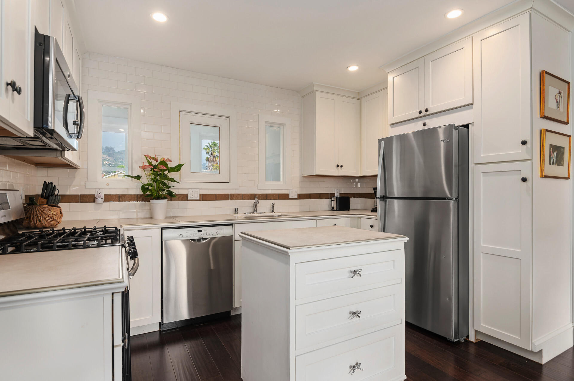 Undisclosed Address Santa Barbara, CA 93101 - Photo 13 of 27 a kitchen with a sink a refrigerator and a stove top oven