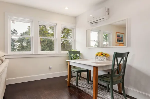 a view of a dining room that has a table and chairs in it
