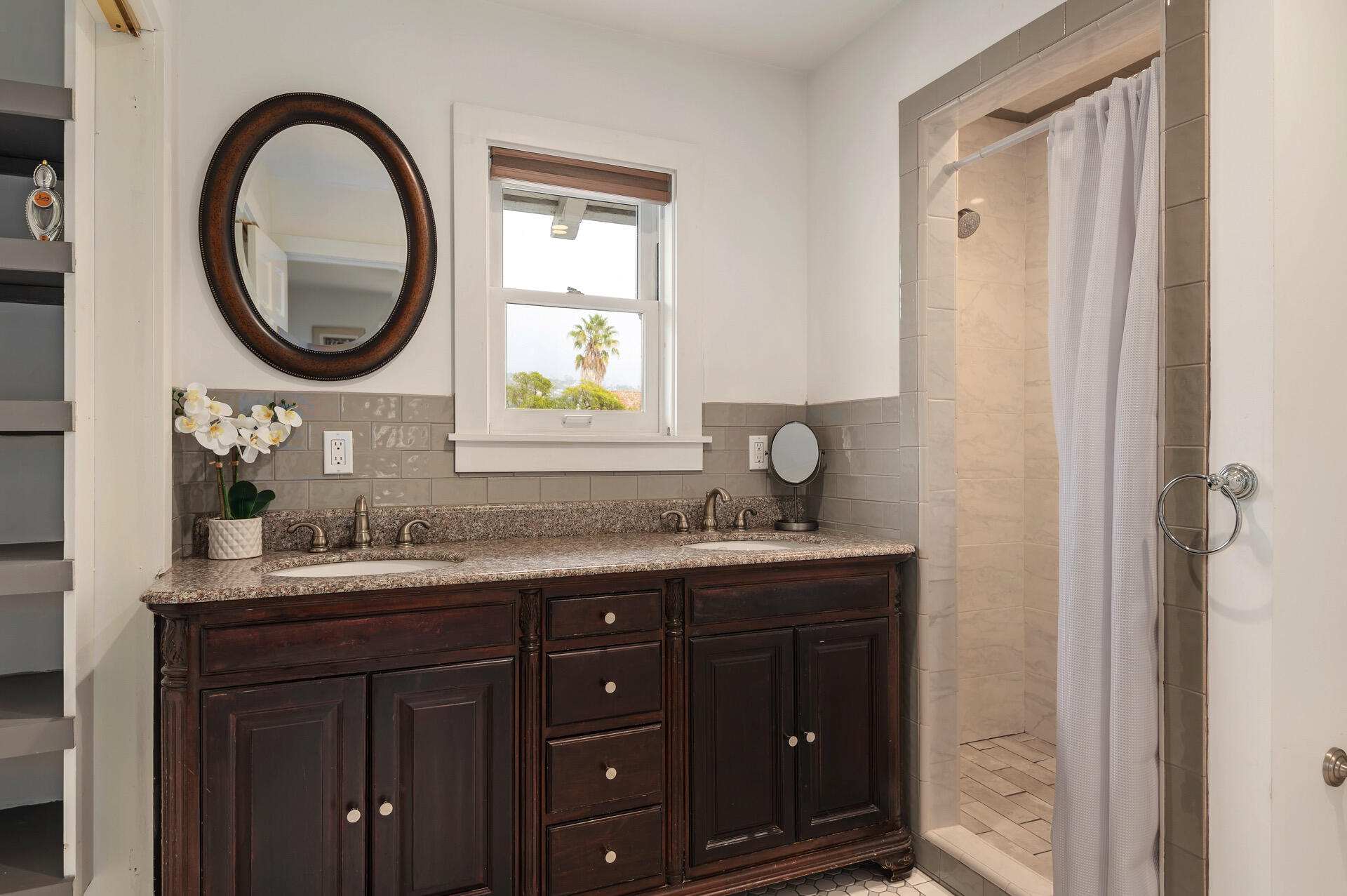 Undisclosed Address Santa Barbara, CA 93101 - Photo 17 of 27 a bathroom with a granite countertop sink a mirror and a window
