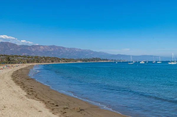 a view of an ocean with a mountain in the background