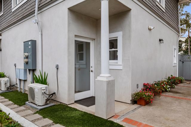 a view of a entryway of house with flower pots