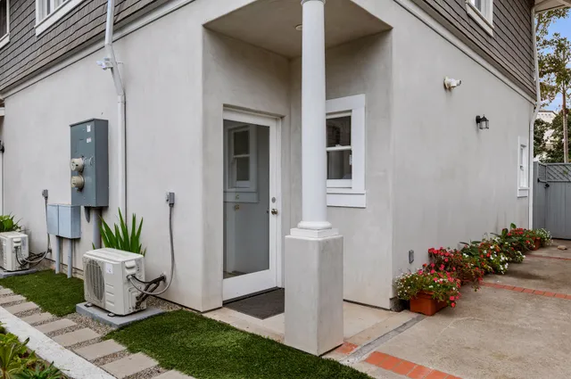 a view of a entryway of house with flower pots