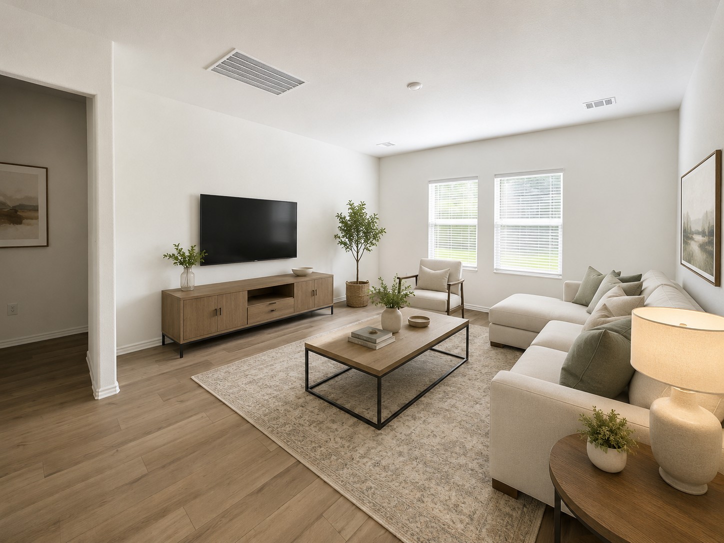 2113 Four Waters Loop Georgetown, TX 78628 - Photo 6 of 26 Virtually Staged, Well-lit living room with abundant natural light from wide windows and light wood-tone flooring.