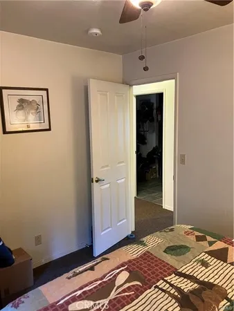 a bed sitting in a bedroom next to a lamp