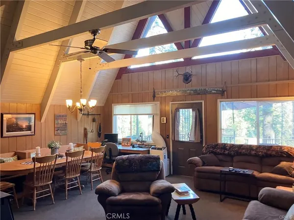 a living room with furniture a window and a table