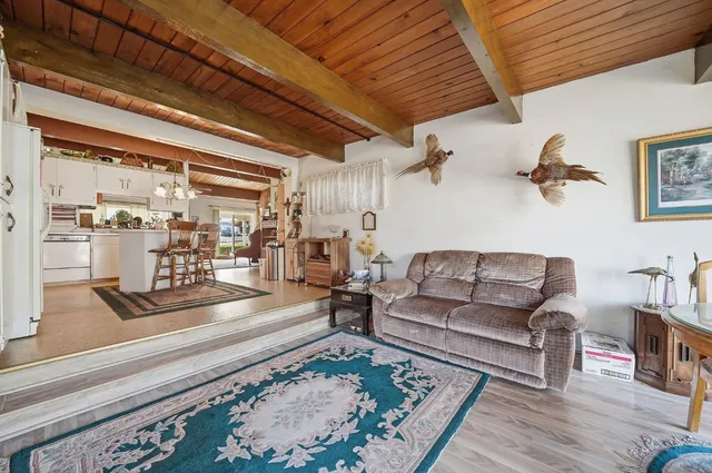 a living room with furniture wooden floor and a table