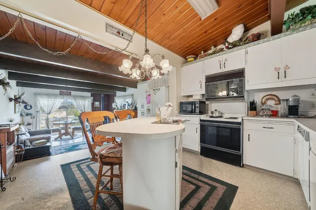 a kitchen with a sink a stove and cabinets