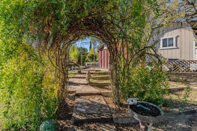 a view of a backyard with sitting area