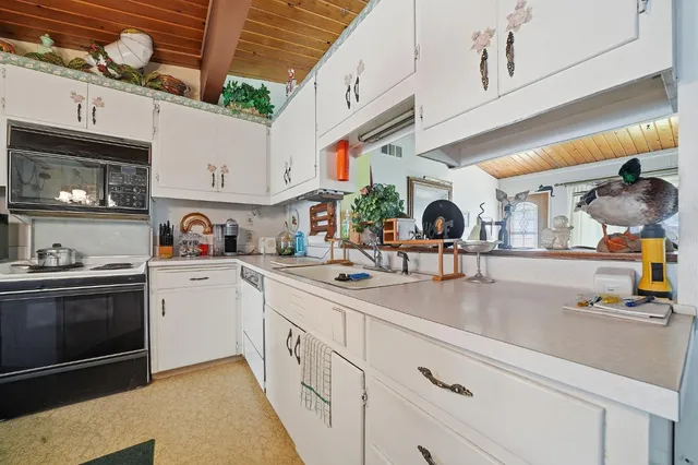 a kitchen with stainless steel appliances granite countertop a sink and a stove