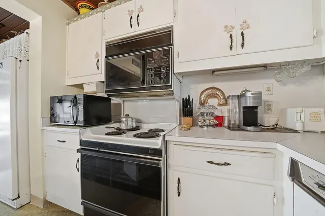a kitchen with stainless steel appliances granite countertop a stove microwave and sink