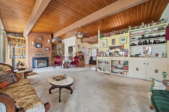 a view of a room with lots of furniture and clutter