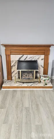 a bedroom with a bed a flat tv screen and a dresser