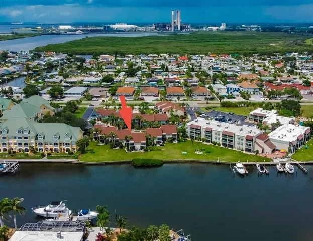an aerial view of a houses with a lake