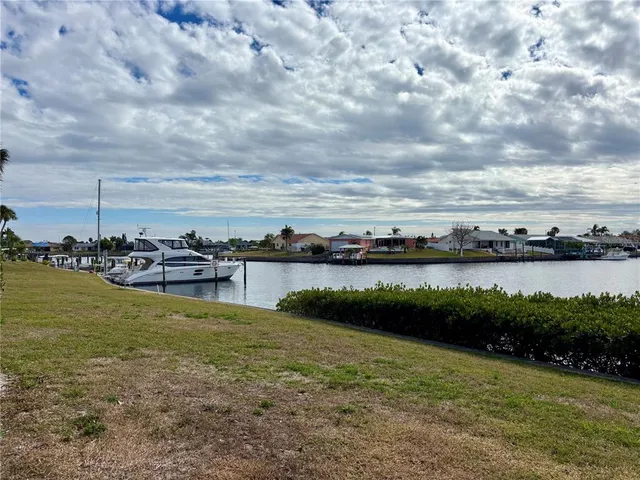 a view of a lake with houses in the back