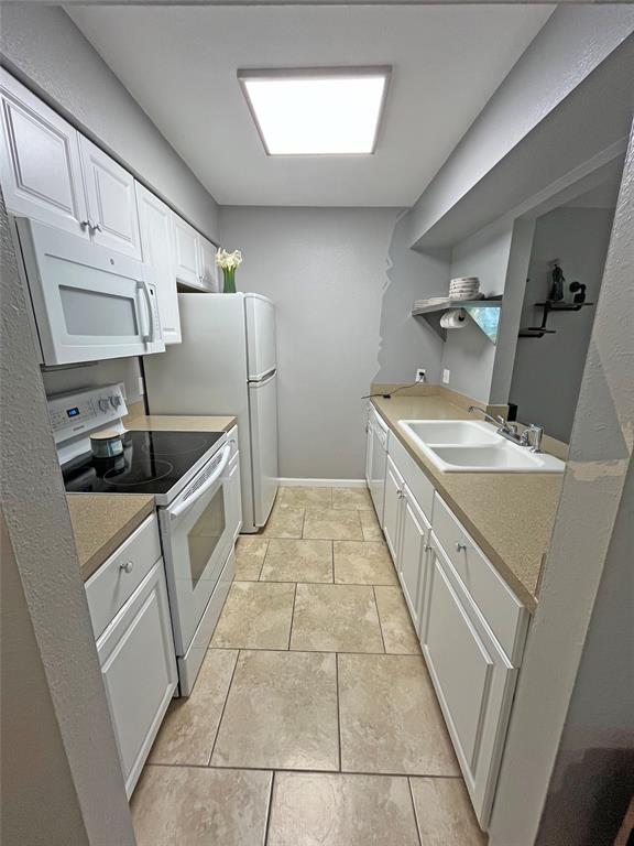 1705 Crossing Place, Unit 131 Austin, TX 78741 - Photo 4 of 13 a kitchen with stainless steel appliances granite countertop a sink stove and cabinets