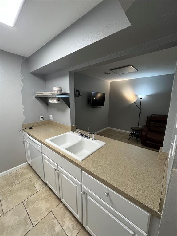 1705 Crossing Place, Unit 131 Austin, TX 78741 - Photo 5 of 13 a kitchen with a sink and a refrigerator