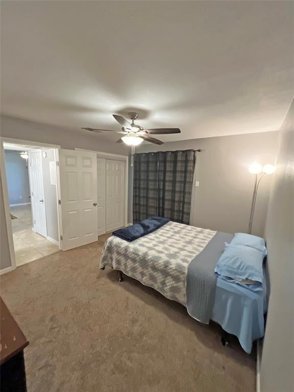 1705 Crossing Place, Unit 131 Austin, TX 78741 - Photo 8 of 13 a bedroom with a bed and a chandelier