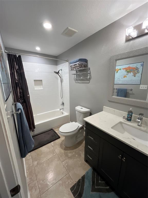 1705 Crossing Place, Unit 131 Austin, TX 78741 - Photo 10 of 13 a bathroom with a sink a toilet a mirror and shower