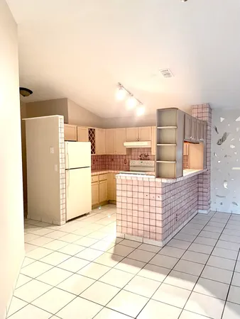 a kitchen with a white cabinets and white appliances