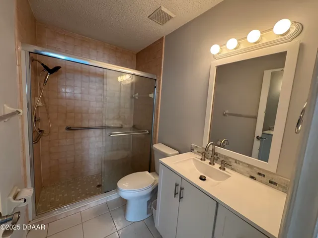 a bathroom with a sink mirror vanity and toilet